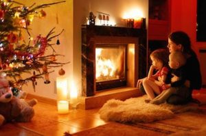 family around fireplace image