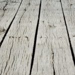 warped cracked boards, on a backyard deck
